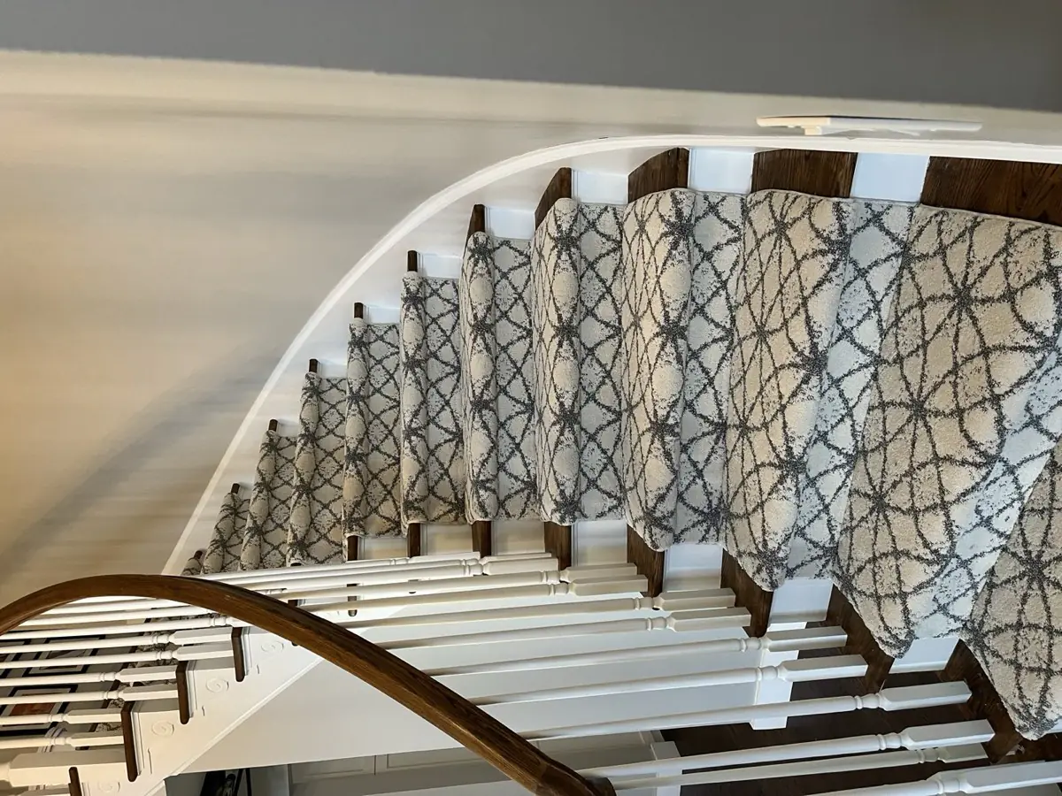 Patterned runner following a curved staircase