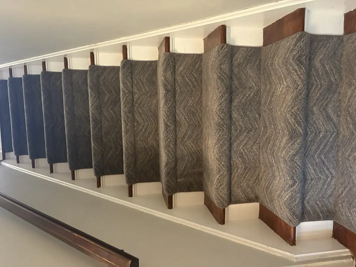 Gray chevron runner on dark stained treads